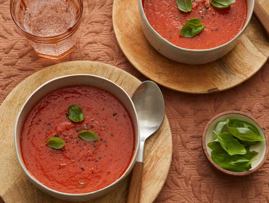 Side-by-side comparison of a homemade plain tomato soup and a store-bought version with added spices and ingredients.